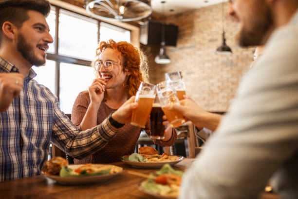 istock Friends eating together making a toast having fun 1387257924