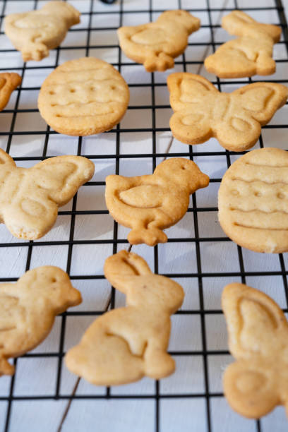 istock Cooked cookies in the form of Easter symbols cool down on a metal grate for baking. Selective focus 1387258011