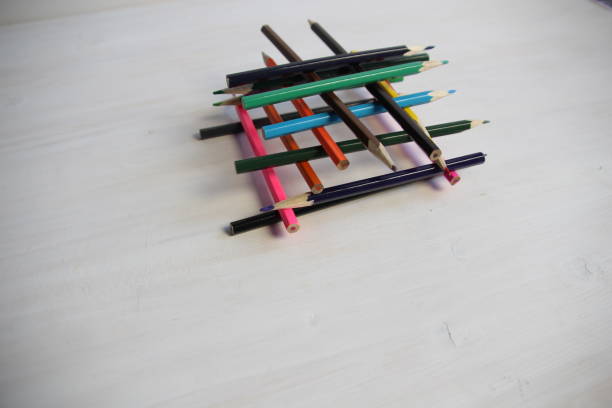 istock colorful wooden sharp pencils build house on a white background 1387258482