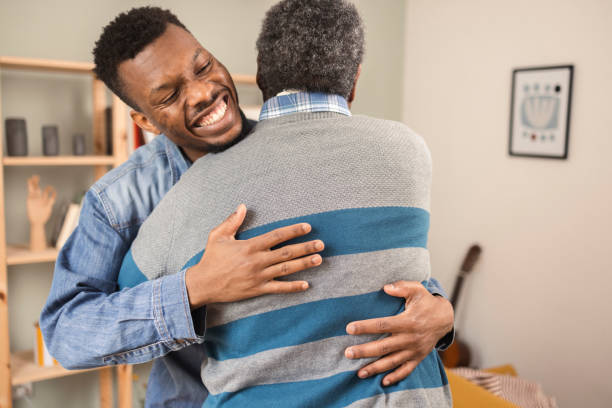 istock Young African American hugging his old father 1387259284