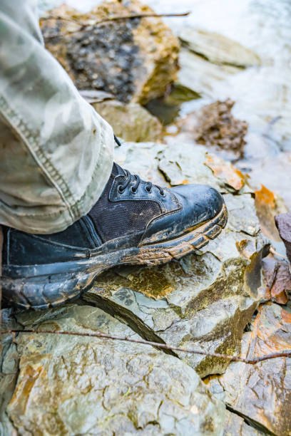 istock Hiking boots in mud, outdoor activity theme, get out there, spring season 1387259569