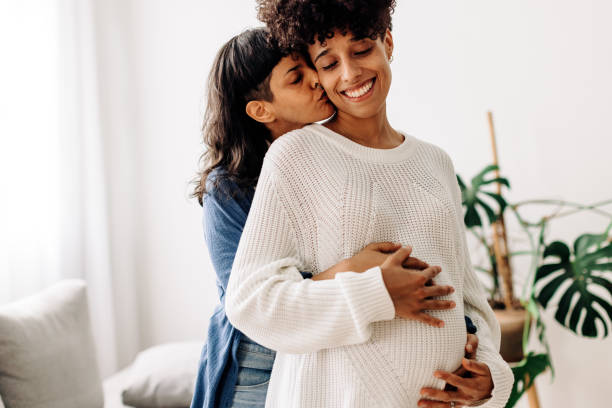 istock Affectionate young woman bonding with her pregnant wife 1387259687