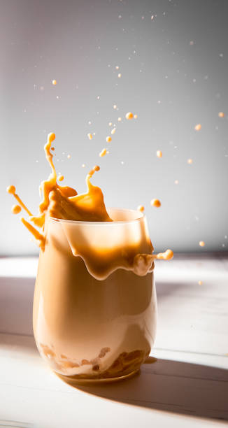 istock iced or frozen coffee in a glass, splash with drops, over grey background 1387260285