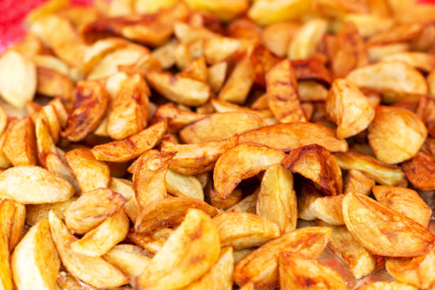 Fresh yummy baked potatoes with a crispy golden crust. Top view, close-up