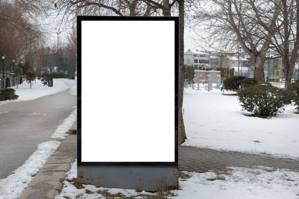 istock Blank billboard in snowy weather in a public park 1387261799