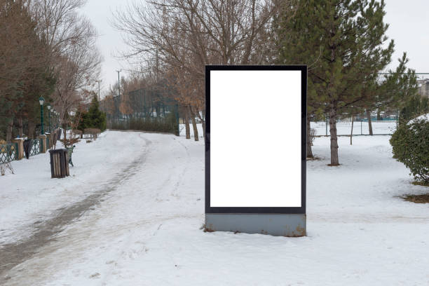 istock Blank billboard in snowy weather in a public park 1387261803