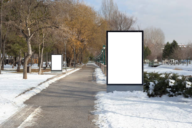 istock Blank billboard in snowy weather in a public park 1387261810