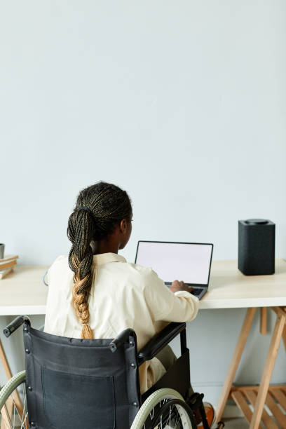 istock Black Woman in Wheelchair Working from Home Minimal 1387262007