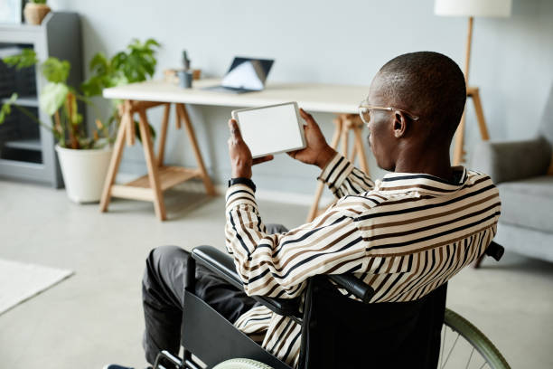 istock African American Man in Wheelchair using Tablet 1387262010