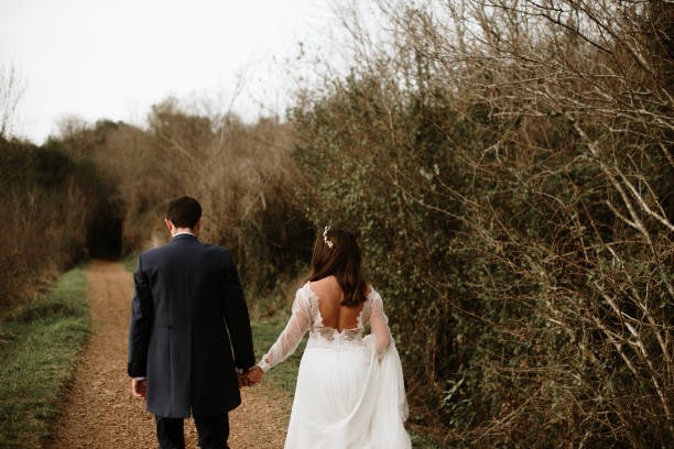 istock Rear view of a just married couple 1387262074