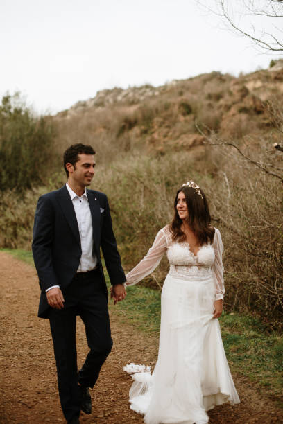 istock Just married couple walking in a forest 1387262095
