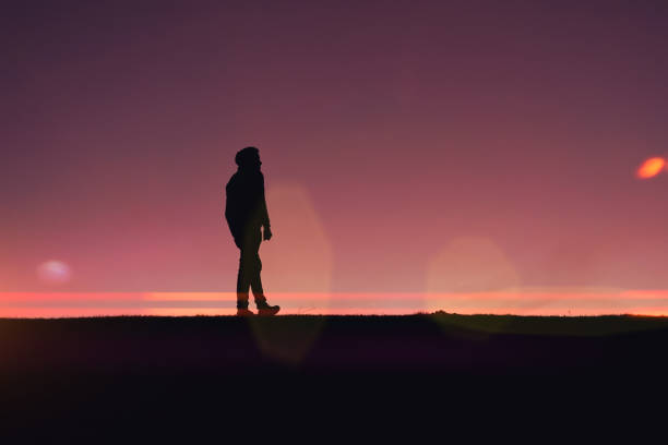 istock man trekking in the mountain with a beautiful sunset 1387262735