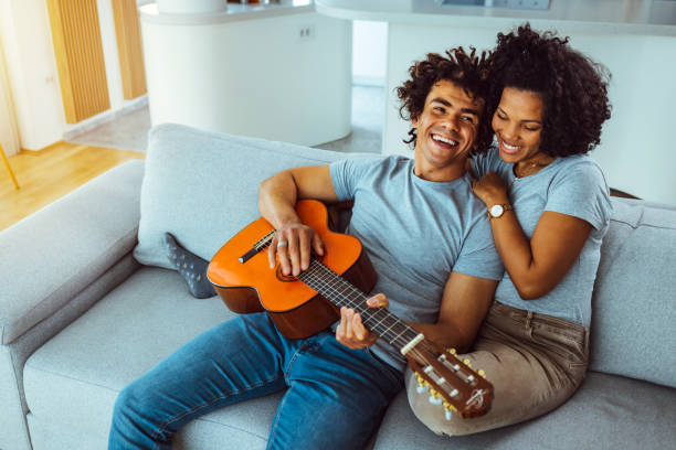 istock Young couple playing classical guitar and singing 1387263643