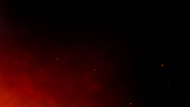 Smoke, flying up sparks and fire particles on dark background