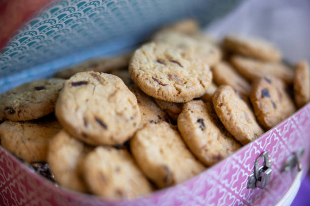 Close-up on baked chocolate chip cookies in a tin box at confectioner's