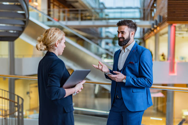 istock Business people talking in the hall 1387266762
