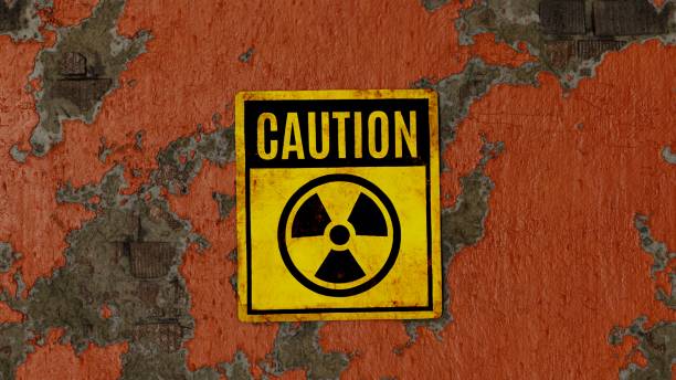 Radioactivity sign on an orange brick wall Radioactivity sign - caution, on an orange painted peeling brick wall chornobyl photos stock pictures, royalty-free photos & images