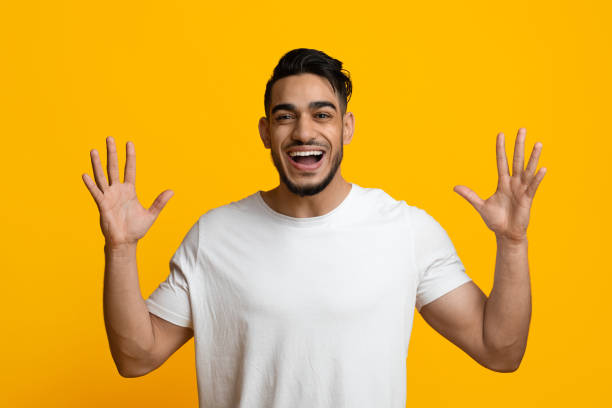 istock Emotional middle eastern man raising hands up 1387268086