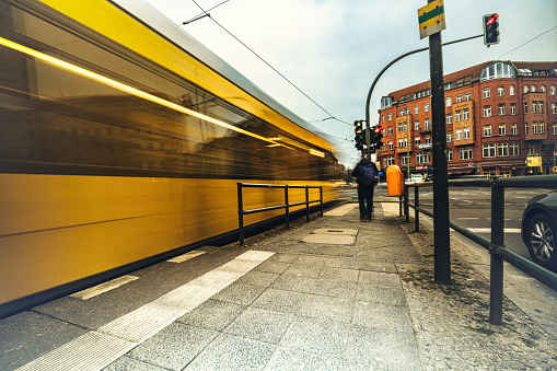 yellow street car approaching tram station at Rosenthaler Platz in Berlin