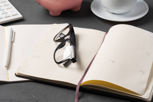 istock Office desk with notepad, glasses and supplies 1387269759