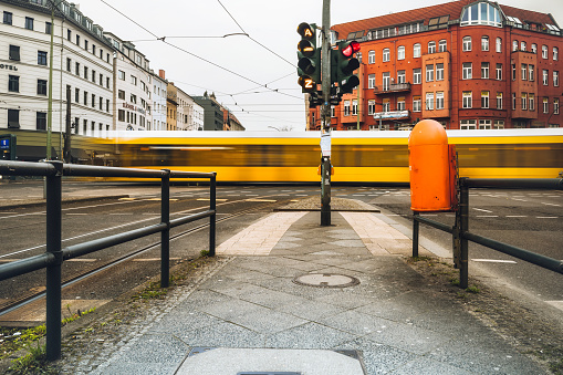 yellow street car passing crossroad a  Rosenthaler Platz in Berlin