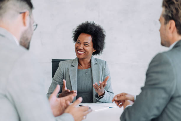 istock Group of business persons talking in the office. 1387273996