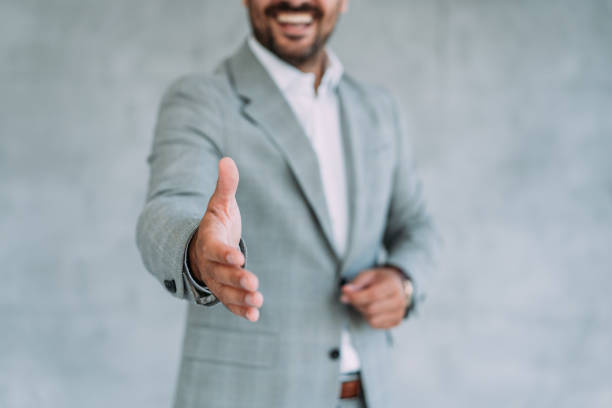 istock Businessman giving hand for a handshake. 1387274050