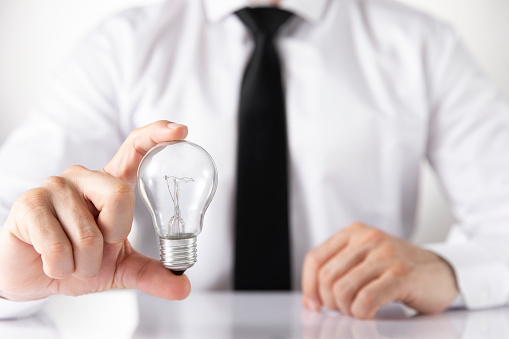 New idea concept with businessman and light bulb