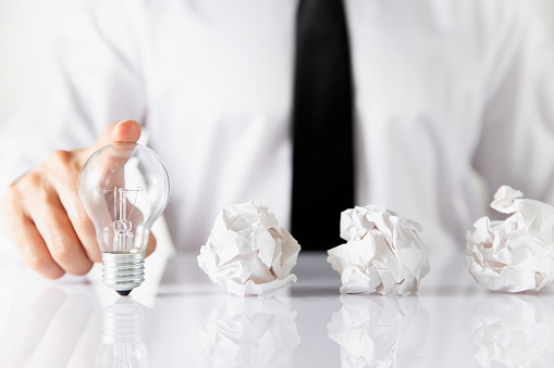 New idea concept with businessman and light bulb