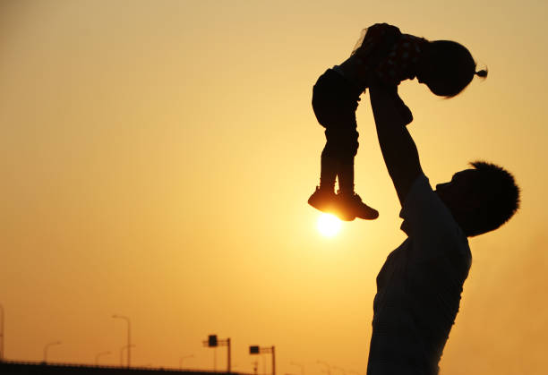 istock silhouette of father and daughter 1387276871