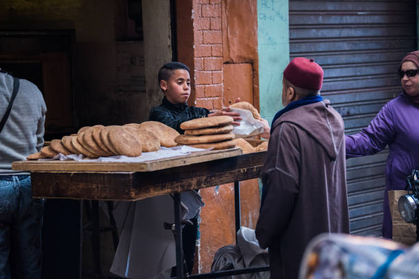 Marrakesh, Morocco - February 28, 2018: Trader in a work routine in a store of ancient Medina district of Marrakech.