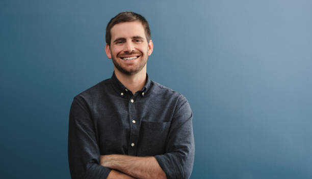 istock Studio shot of a young man standing against a blue background 1387279201