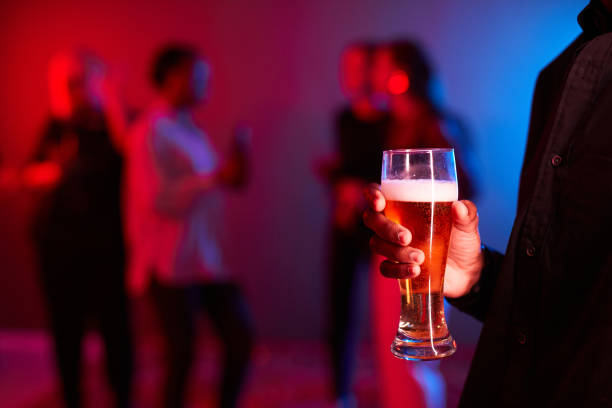 istock Man Holding Beer in Club 1387279235