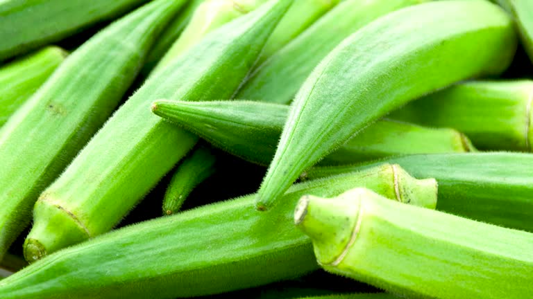 A bundle of fresh Lady's finger or Green okra at agriculture field. Close up view.