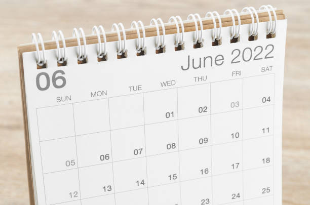 June 2022 desk calendar on wooden background. The June 2022 desk calendar on wooden background. june stock pictures, royalty-free photos & images