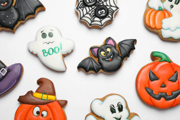 istock Tasty Halloween cookies on white table, flat lay 1387282276