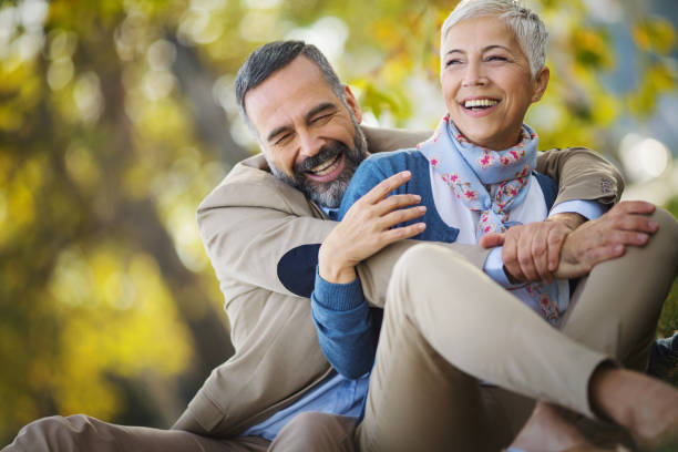 istock Mature couple relaxing in the park. 1387282481
