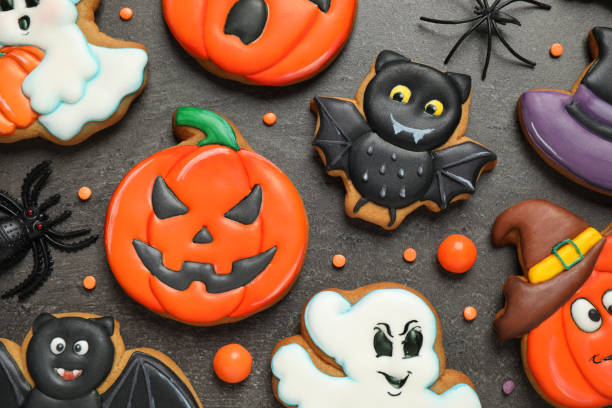 istock Tasty cookies and sweets for Halloween party on black table, flat lay 1387282908
