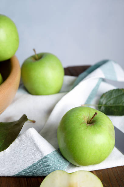 istock Fresh ripe green apples on wooden table 1387284051