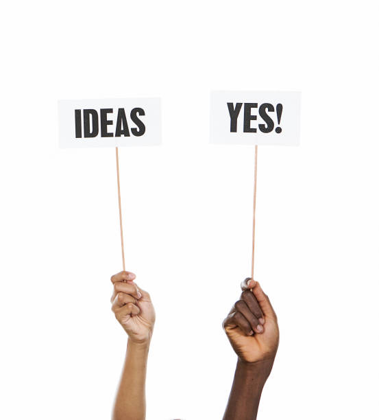 Hands hold up signs saying Ideas and Yes!