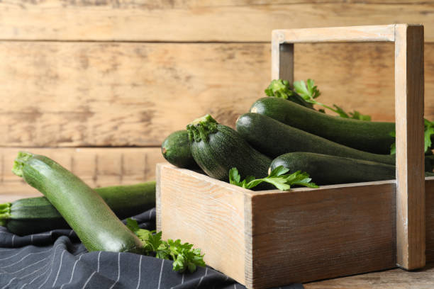istock Crate with green zucchinis and parsley on table 1387285477