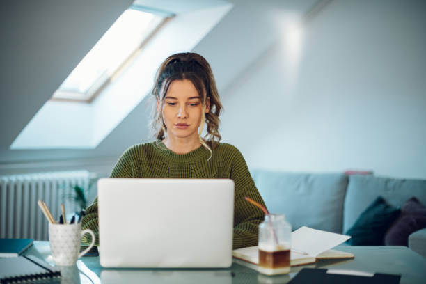 istock Woman working from a home on her a laptop 1387286288
