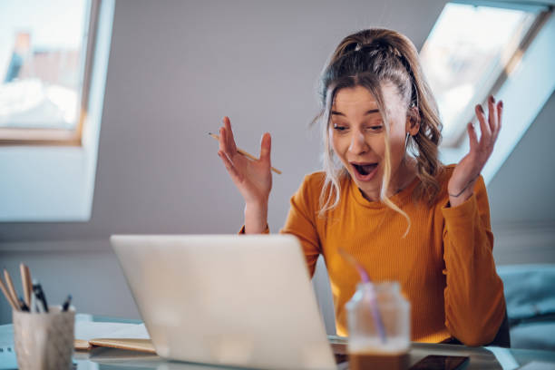 istock Woman having web call on a laptop while working at home 1387286295