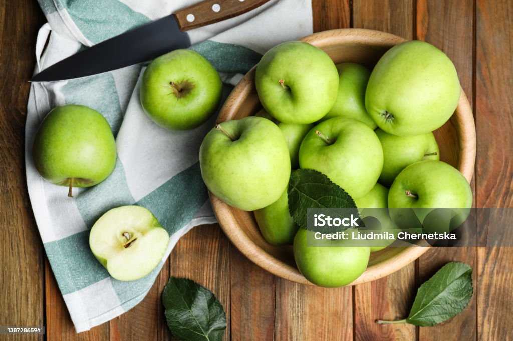 Fresh ripe green apples and knife on wooden table, flat lay Apple - Fruit Stock Photo