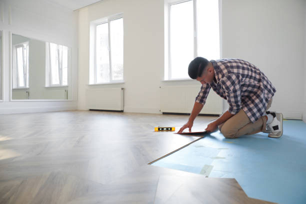 istock Professional worker installing new parquet flooring indoors 1387286616