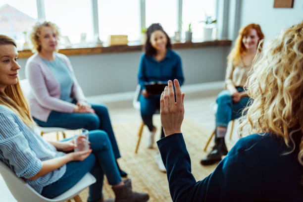 istock Shot of middle aged multiethnic people talking together during anonymous group therapy 1387286647