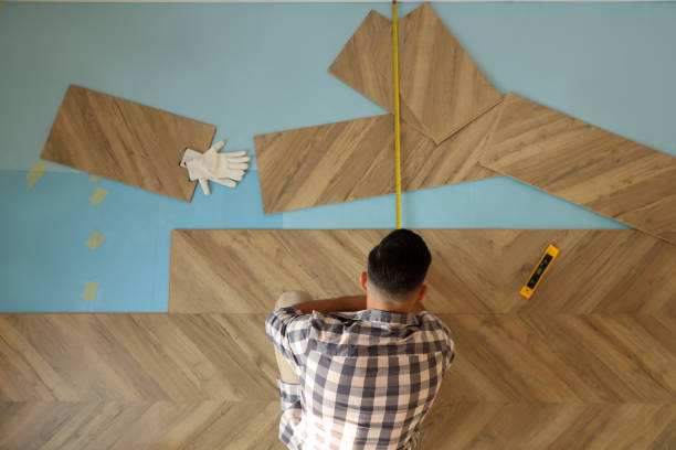 istock Professional worker installing new parquet flooring indoors, top view 1387287268