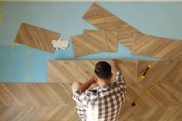 istock Professional worker installing new parquet flooring indoors, top view 1387287303