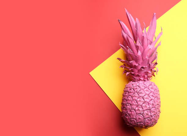 istock Pink pineapple on color background, top view with space for text. Creative concept 1387287811