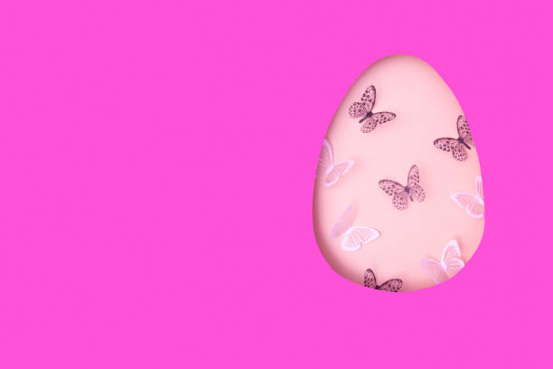 Easter egg cut out of paper and butterflies. Creative Easter holiday concept with copy space.